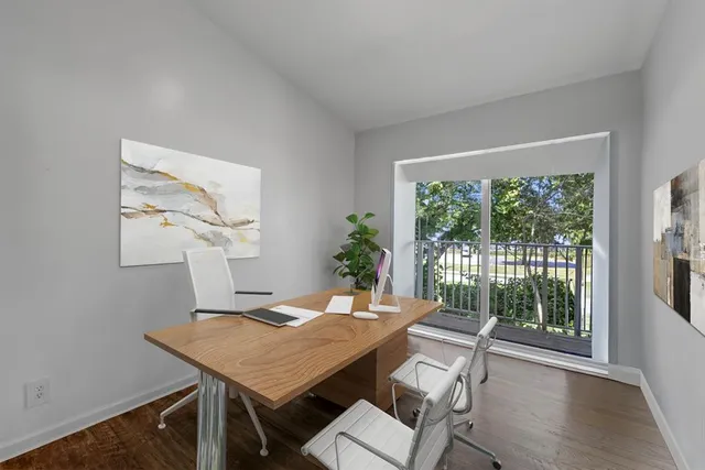 a view of a dining room with furniture window and wooden floor