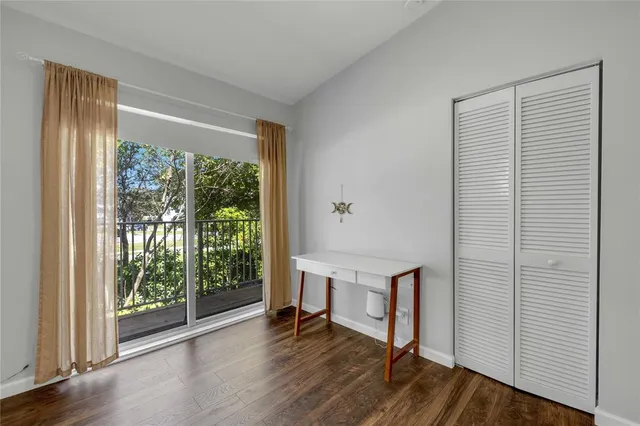 a view of room with window and wooden floor