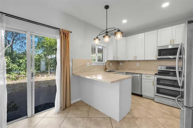 a kitchen with a refrigerator and a sink