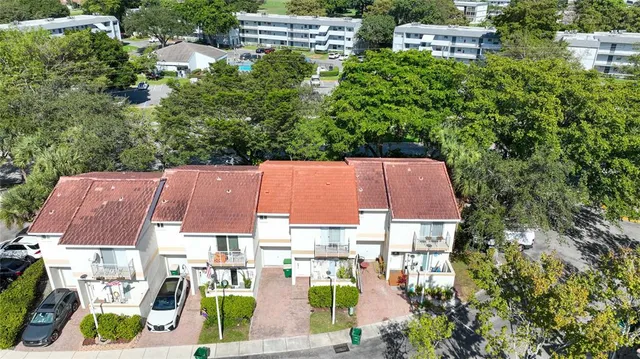 an aerial view of multiple houses with yard