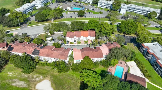 an aerial view of residential houses with outdoor space and street view