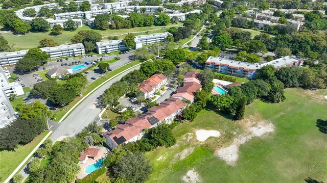 an aerial view of residential houses with outdoor space and street view