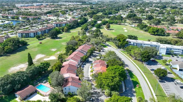 an aerial view of residential houses with outdoor space and street view