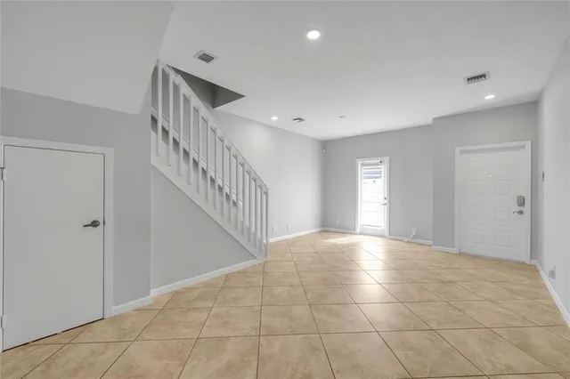 a view of an empty room and staircase