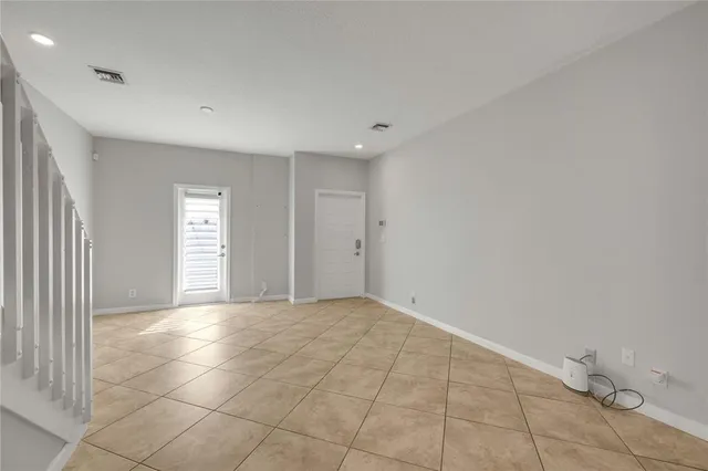 a view of a livingroom with an empty space and a window