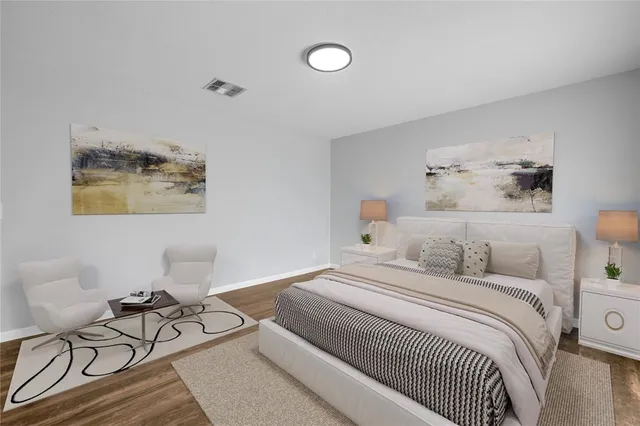 a bedroom with a bed a table and chair