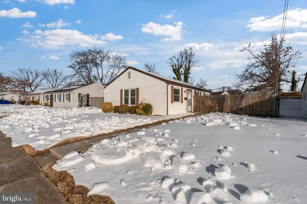 a view of a white house with a yard