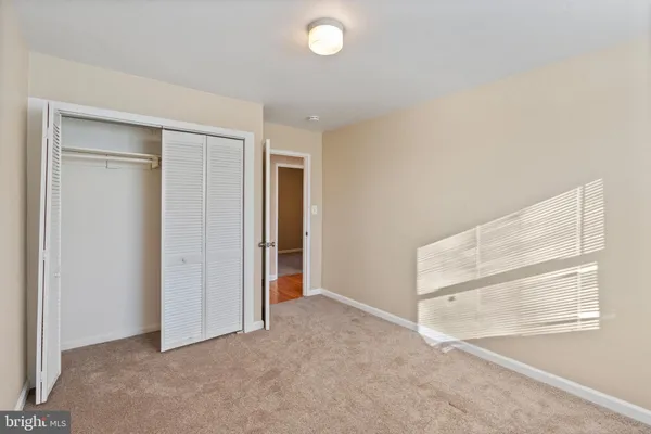 an empty room with windows and closet