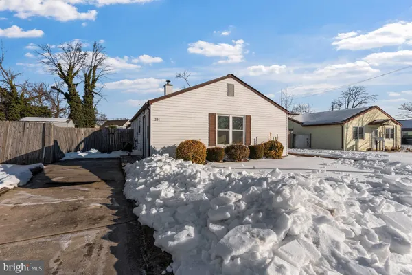 a view of a house with a yard covered with snow