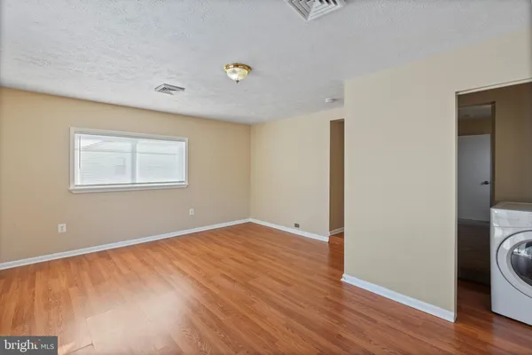 a view of a room with wooden floor and sink