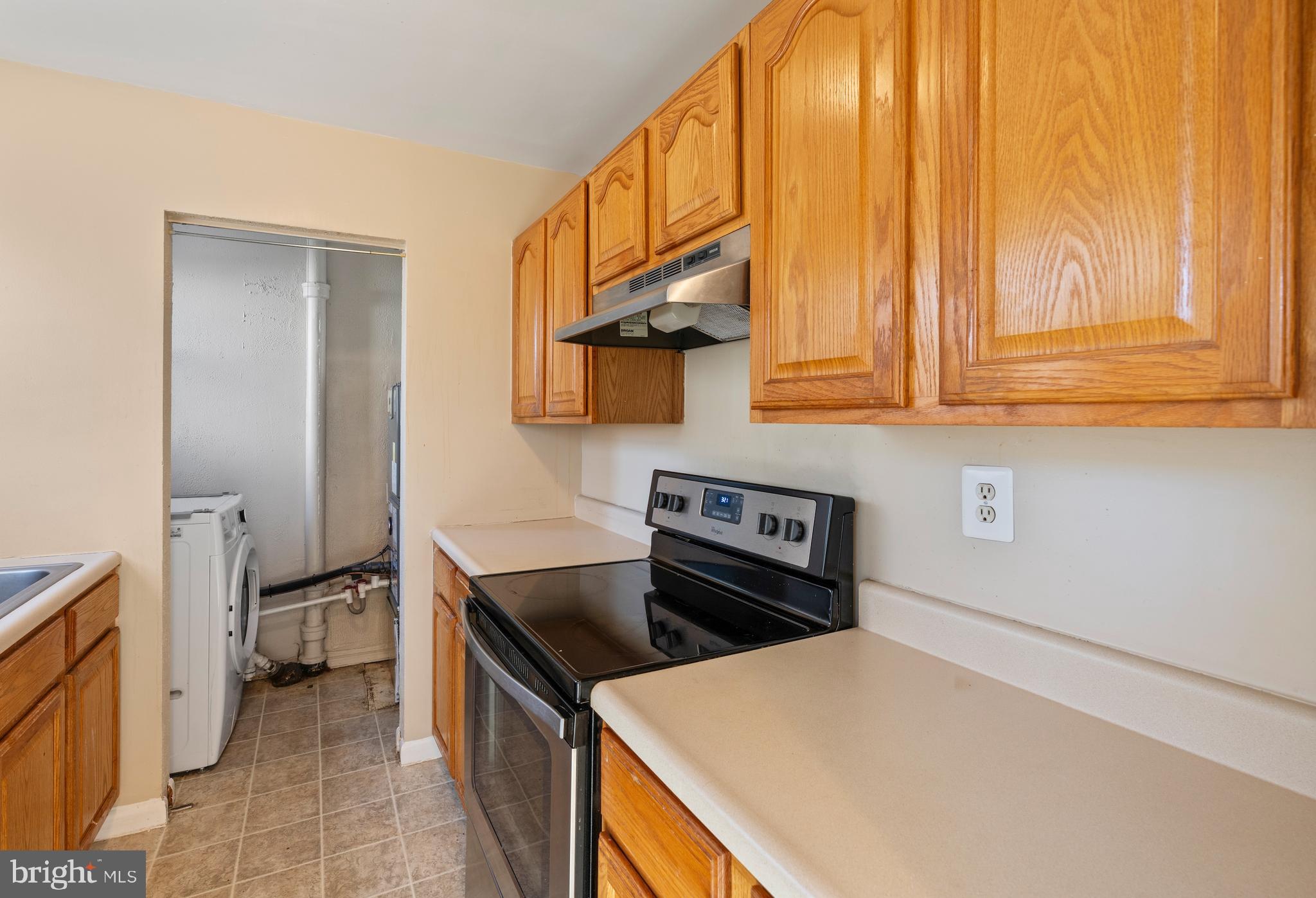 1224 Guildford Road Glen Burnie, MD 21060 - Photo 6 of 22 a kitchen with stainless steel appliances granite countertop a stove a sink and a refrigerator