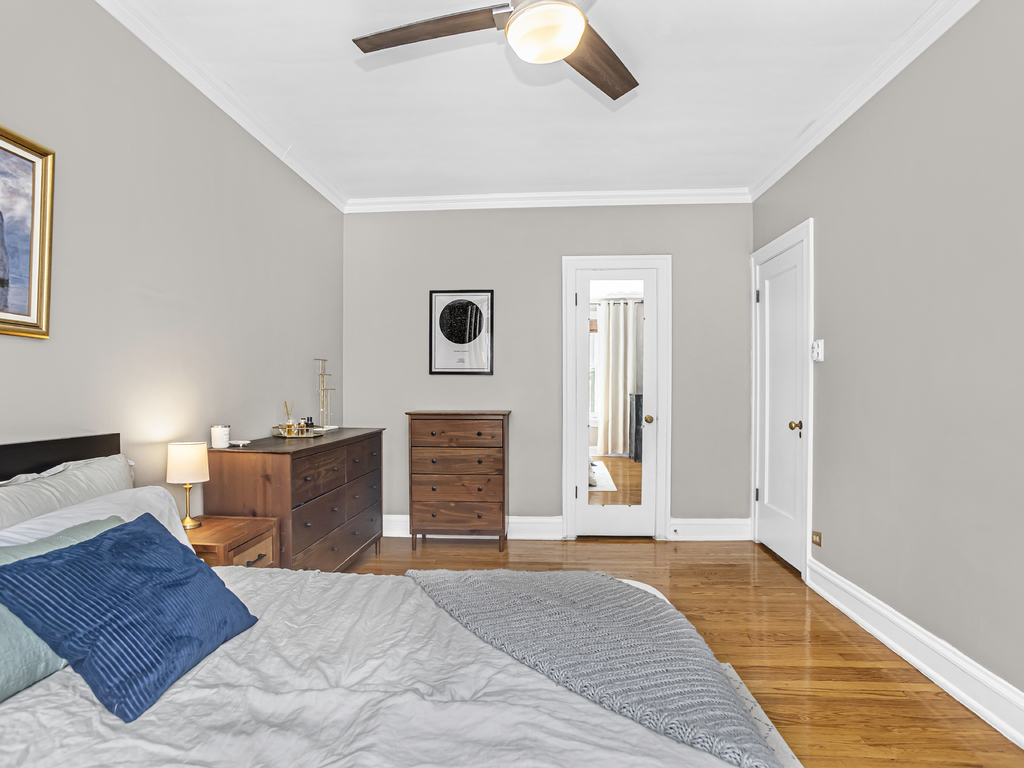 815 Brummel Street, Unit 2 Evanston, IL 60202 - Photo 11 of 16 a bed room with a bed and mirror