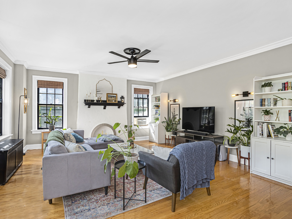 815 Brummel Street, Unit 2 Evanston, IL 60202 - Photo 4 of 16 a living room with furniture a ceiling fan a flat screen tv and a fireplace