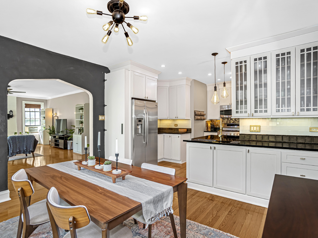 815 Brummel Street, Unit 2 Evanston, IL 60202 - Photo 7 of 16 a kitchen with stainless steel appliances granite countertop a dining table chairs and granite counter tops