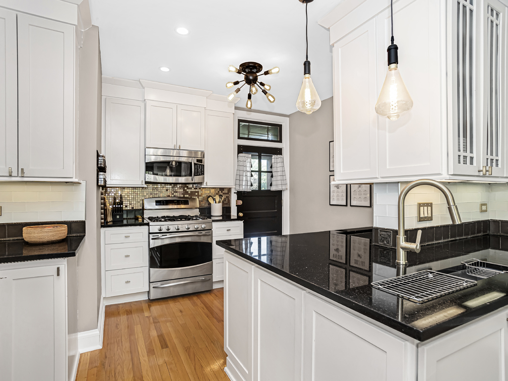 815 Brummel Street, Unit 2 Evanston, IL 60202 - Photo 8 of 16 a kitchen with granite countertop a stove a sink and a refrigerator