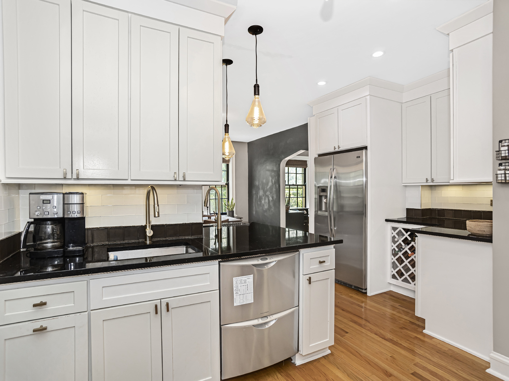 815 Brummel Street, Unit 2 Evanston, IL 60202 - Photo 9 of 16 a kitchen with granite countertop white cabinets and stainless steel appliances