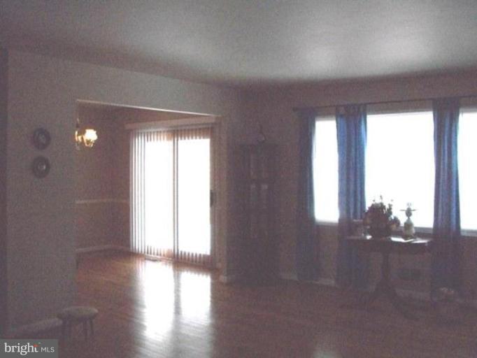 1307 Gatefield Road Catonsville, MD 21228 - Photo 2 of 16 a view of empty room with wooden floor and fan