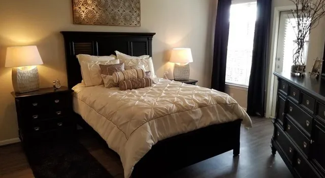 a bedroom with a bed and a mirror