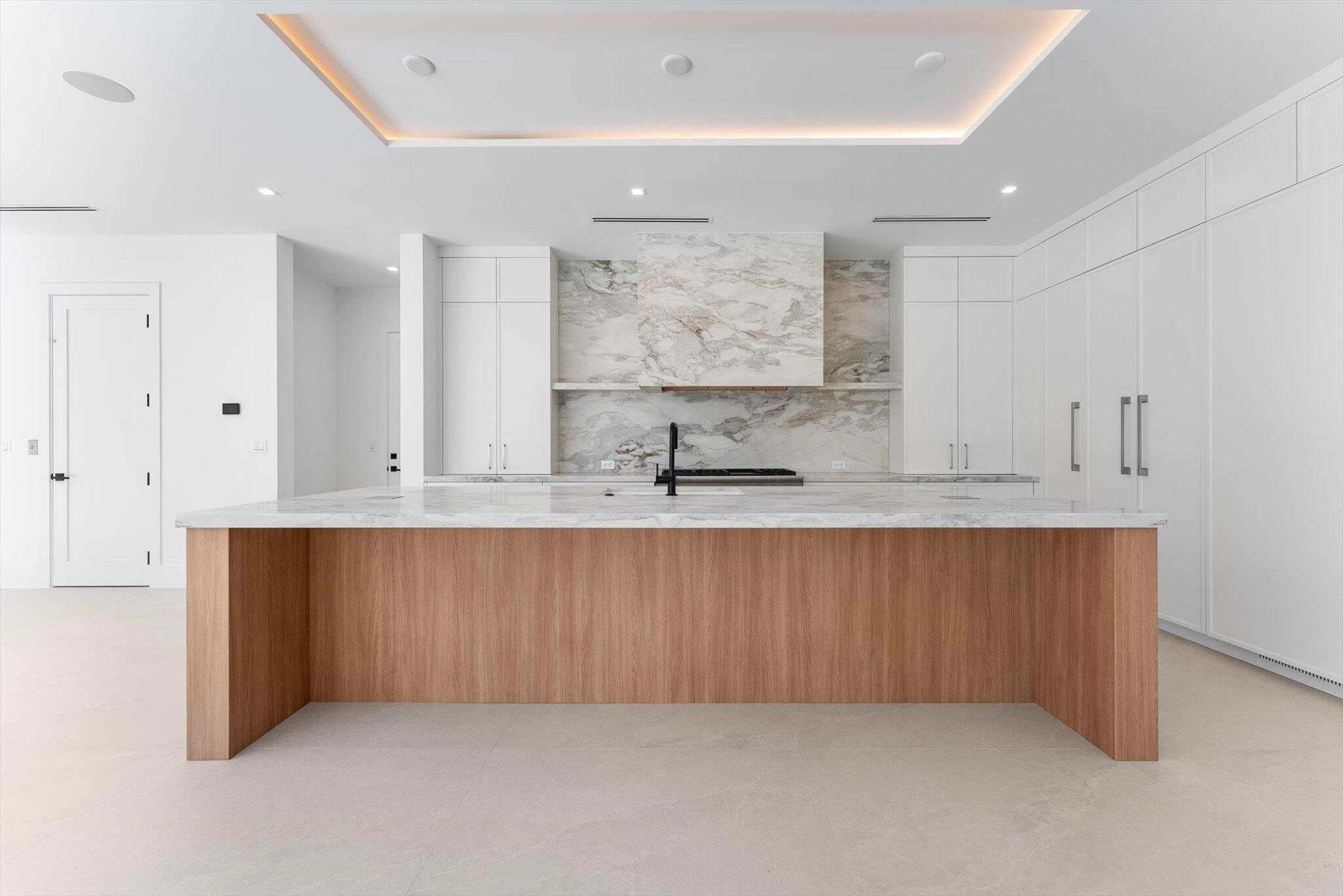 880 Northeast 3rd Avenue Boca Raton, FL 33432 - Photo 12 of 100 a kitchen with stainless steel appliances granite countertop a sink and cabinets