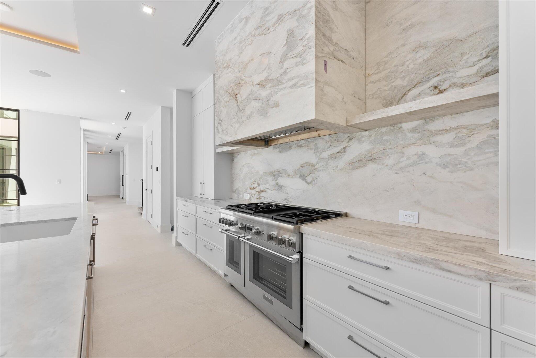 880 Northeast 3rd Avenue Boca Raton, FL 33432 - Photo 18 of 100 a kitchen with stainless steel appliances granite countertop a stove and a refrigerator
