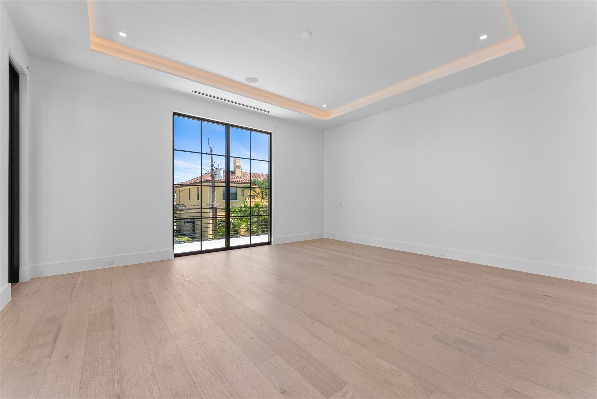 880 Northeast 3rd Avenue Boca Raton, FL 33432 - Photo 45 of 100 a view of an empty room with wooden floor and a window
