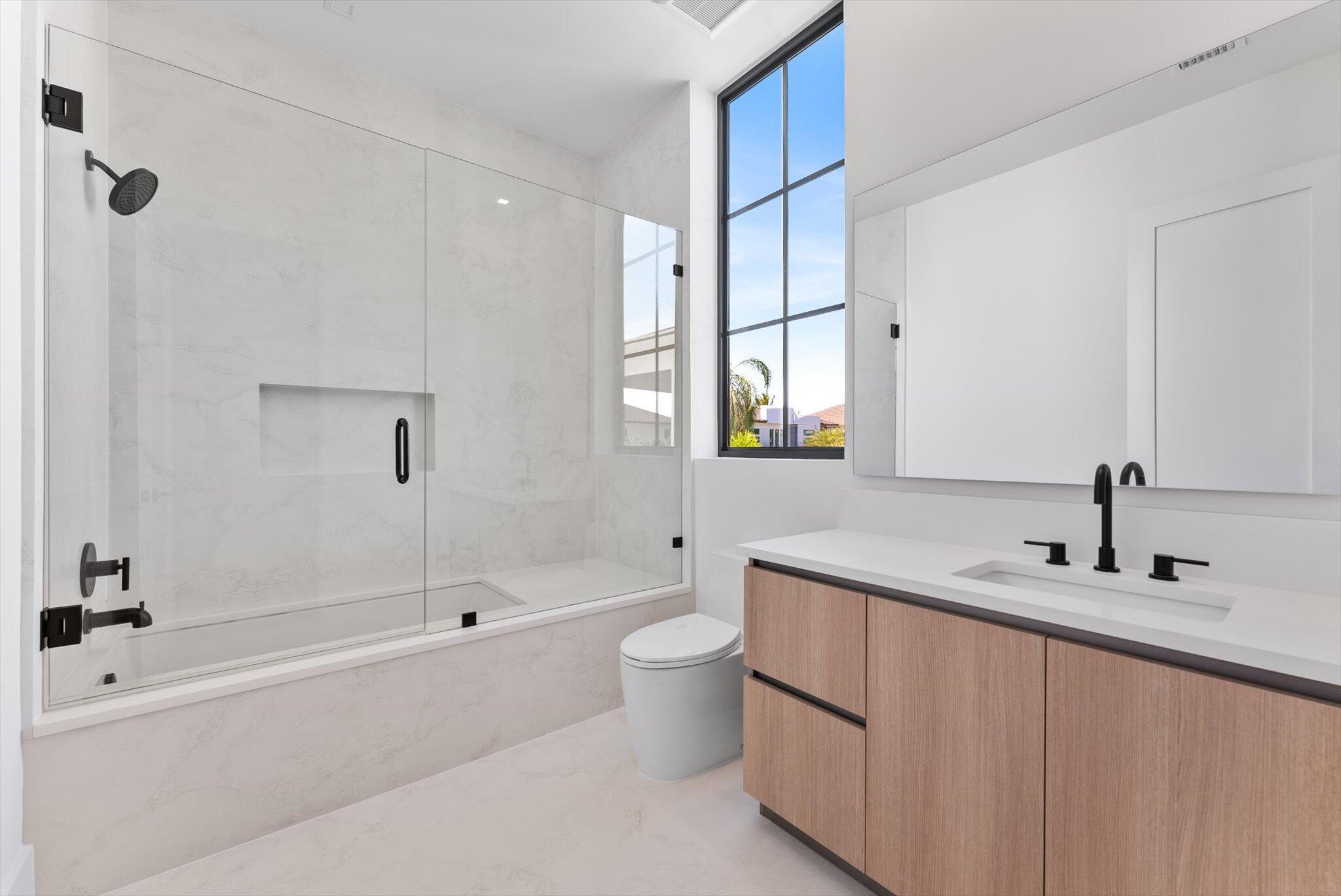 880 Northeast 3rd Avenue Boca Raton, FL 33432 - Photo 68 of 100 a bathroom with a sink a toilet and shower