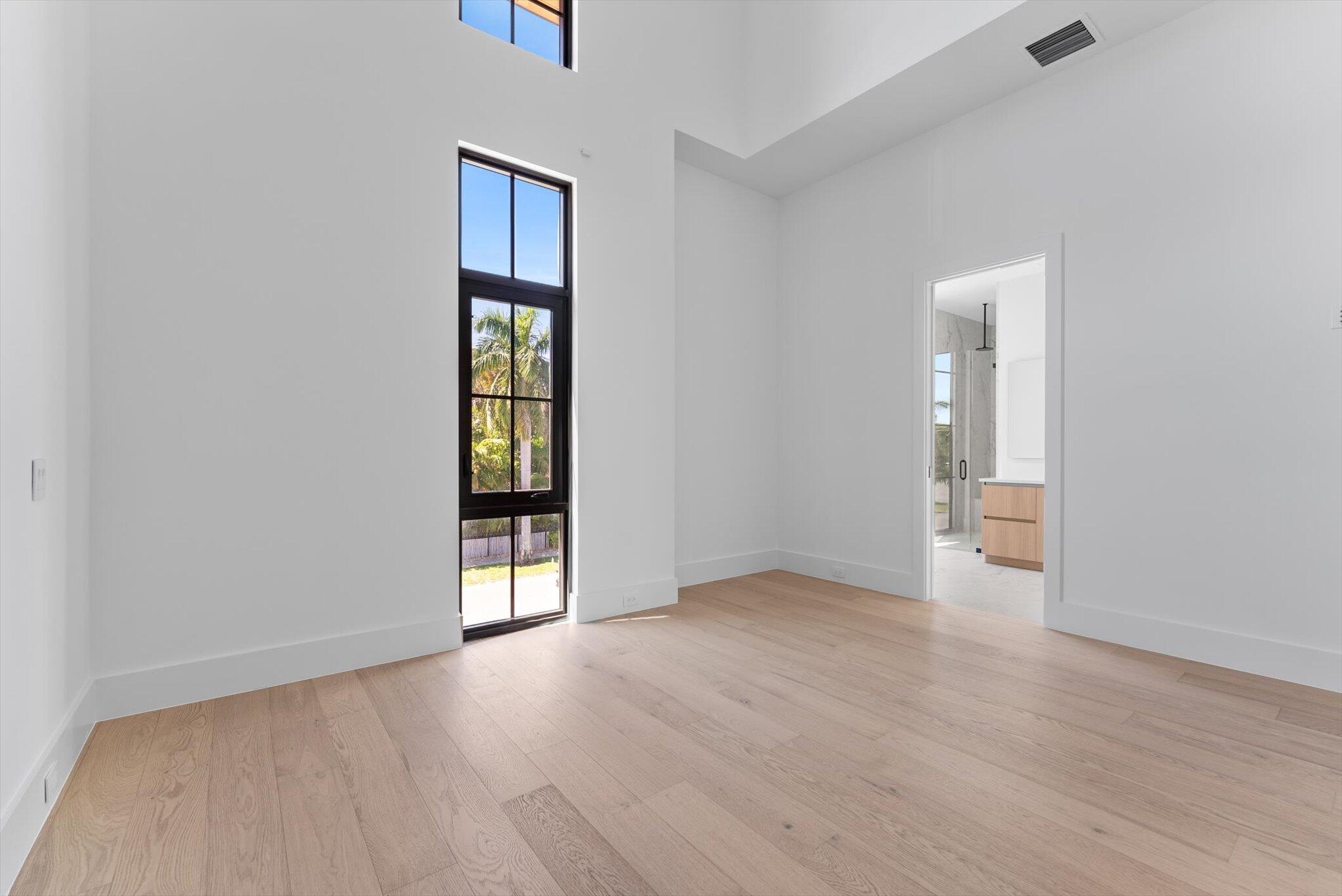 880 Northeast 3rd Avenue Boca Raton, FL 33432 - Photo 70 of 100 an empty room with wooden floor and mirror