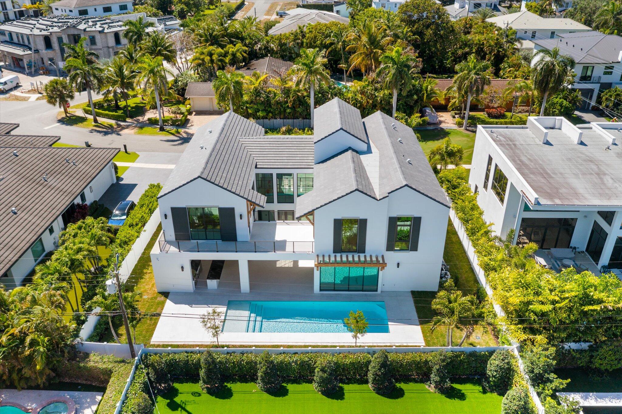 880 Northeast 3rd Avenue Boca Raton, FL 33432 - Photo 88 of 100 a aerial view of a house with swimming pool lawn chairs and plants