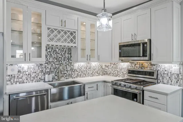 a kitchen with stainless steel appliances a stove sink and microwave