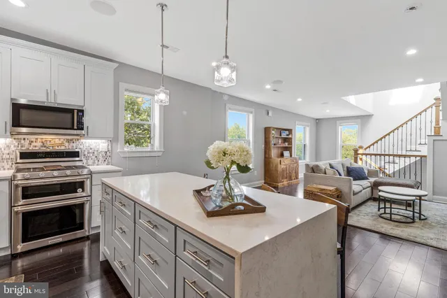 a kitchen with a stove a sink and a refrigerator