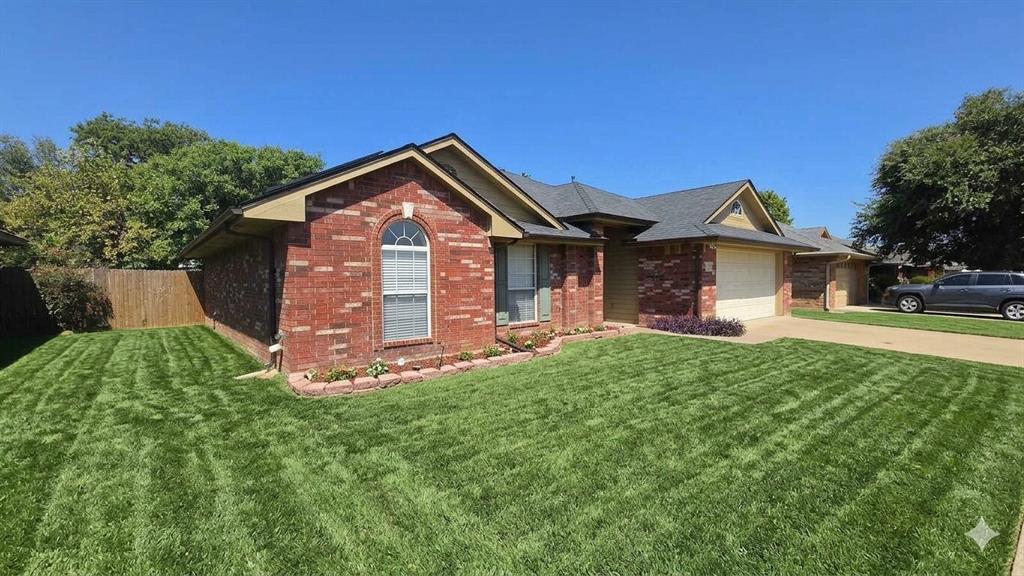 211 Vista Ridge Drive Venus, TX 76084 - Photo 2 of 24 Brick exterior with a gabled roofline, arched window, and integrated garage