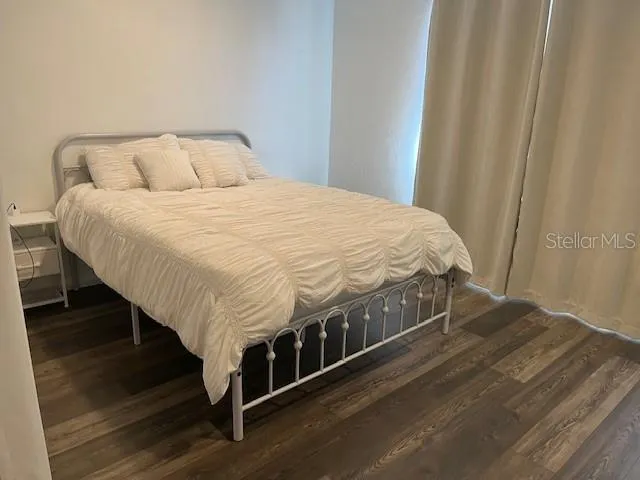 a large bed sitting in a bedroom next to a shower
