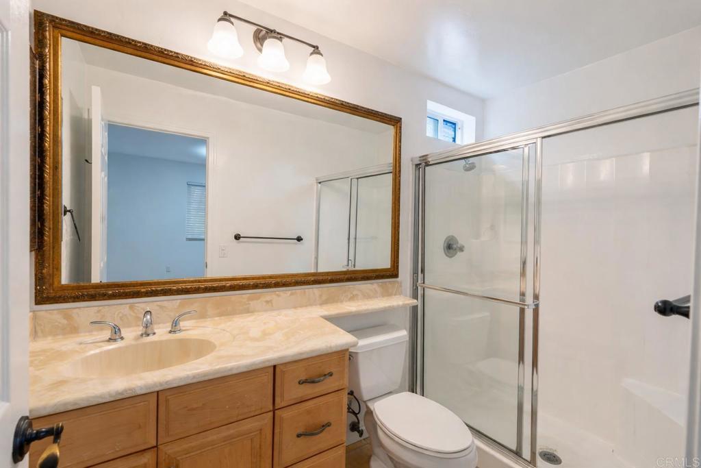 1145 Helix Street, Unit 13 Spring Valley, CA 91977 - Photo 8 of 12 a bathroom with a sink a toilet and shower