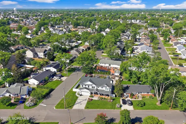 an aerial view of residential houses with outdoor space and street view