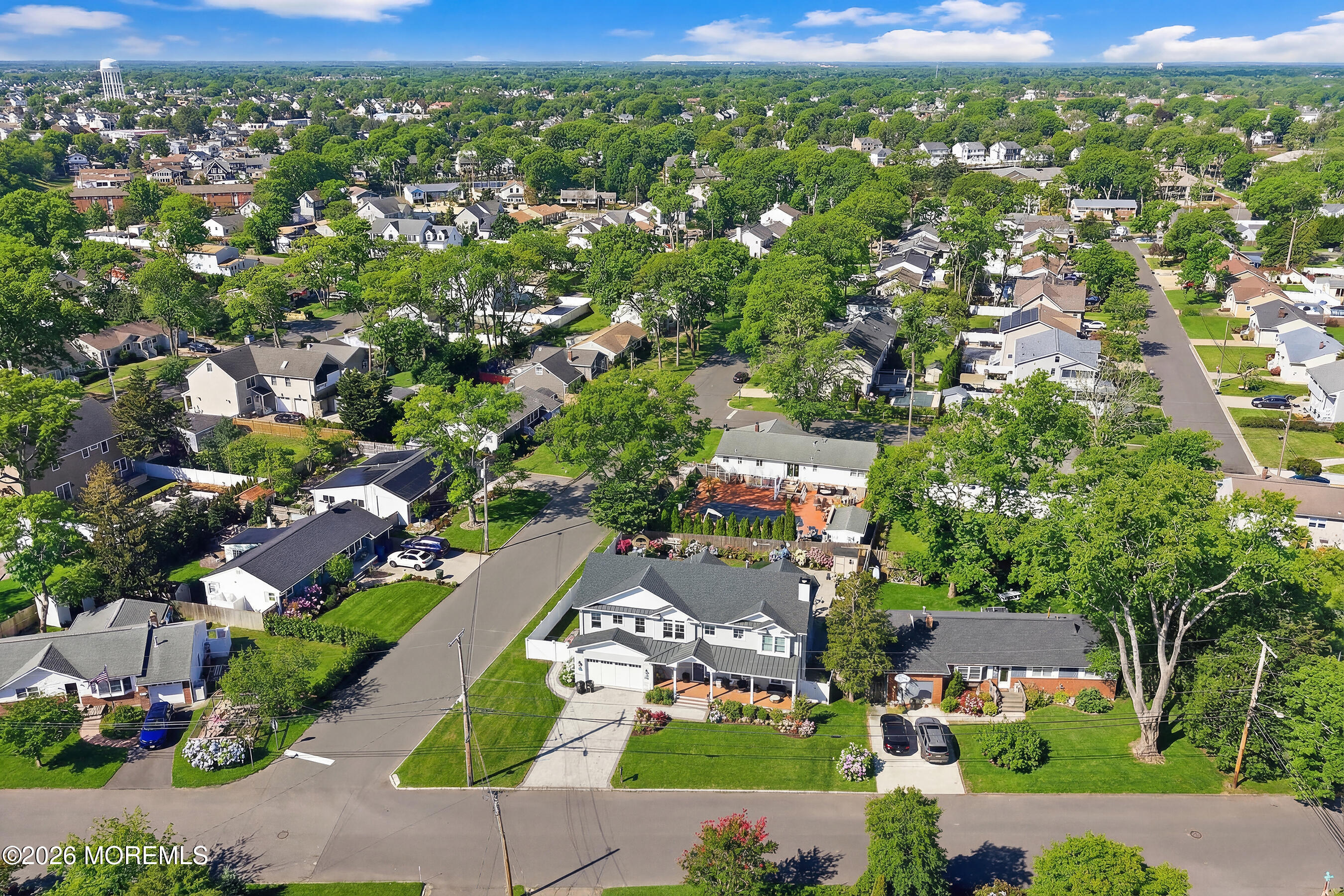an aerial view of residential houses with outdoor space and street view