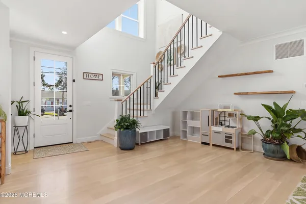 a kitchen with stainless steel appliances kitchen island granite countertop a table chairs sink and cabinets