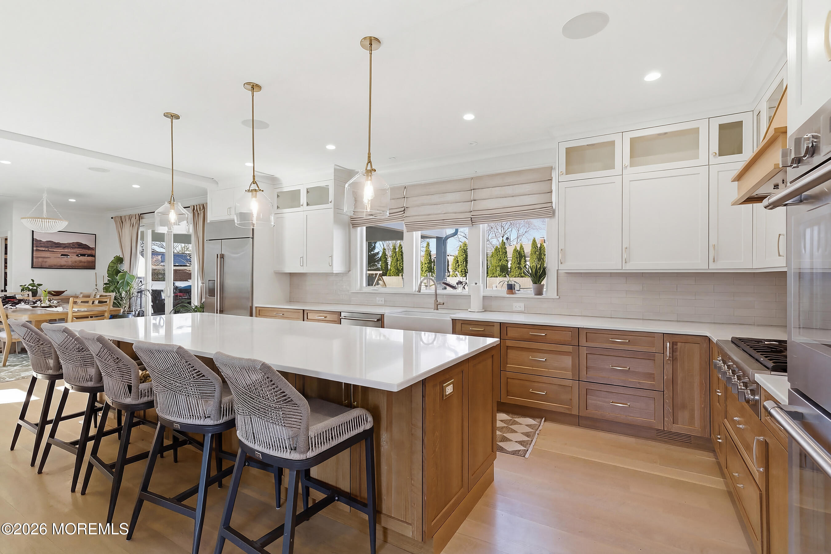 1603 Jackson Street Point Pleasant, NJ 08742 - Photo 7 of 45 a kitchen with stainless steel appliances kitchen island granite countertop a table chairs sink and cabinets