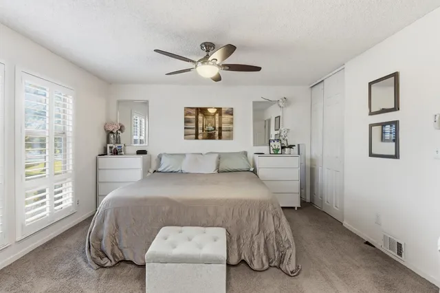 a bathroom with a double vanity sink a toilet and a mirror