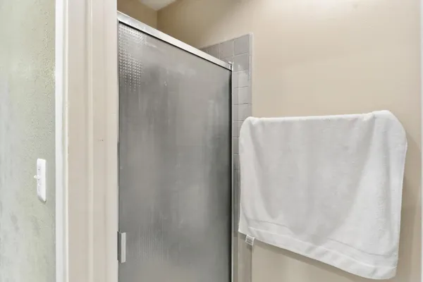 a bed room with a bed a television and a window