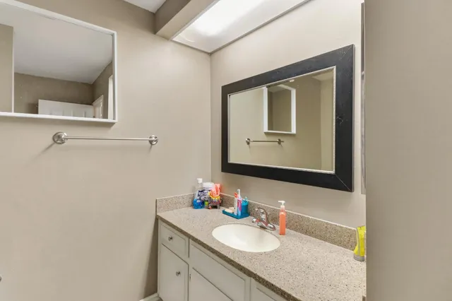 a bedroom with a bed and a refrigerator