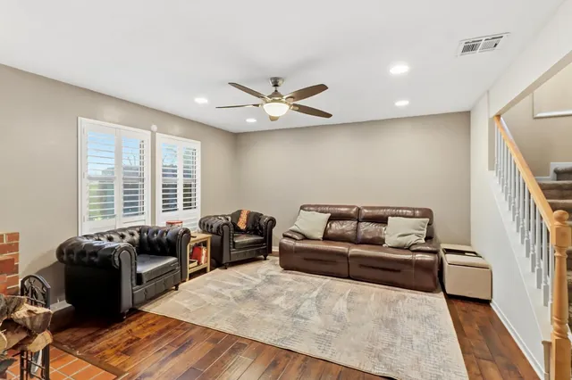 a living room with furniture fireplace and a large window