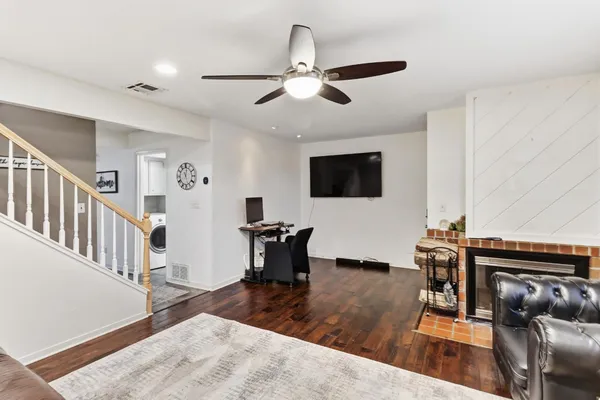 a view of a dining room with furniture and a chandelier fan