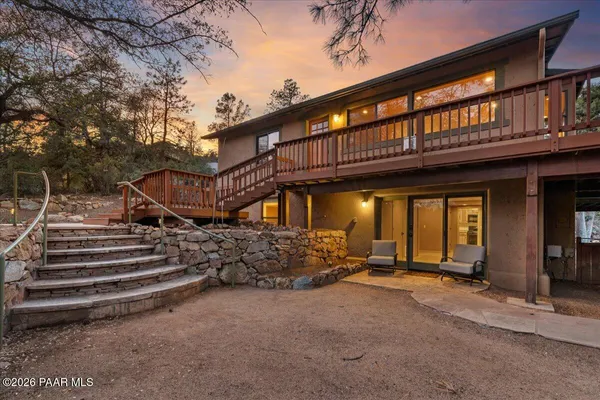 a view of a house with a small yard and wooden fence