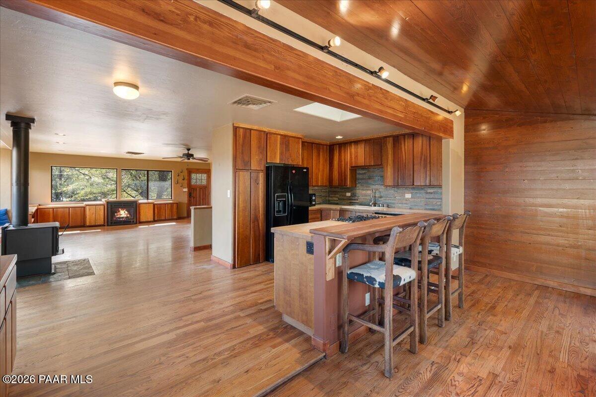 646 South Rancho Vista Drive Prescott, AZ 86303 - Photo 14 of 50 a kitchen with stainless steel appliances a dining table chairs and wooden floor