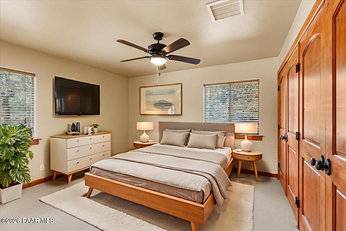 646 South Rancho Vista Drive Prescott, AZ 86303 - Photo 17 of 50 a spacious bedroom with a bed and a flat screen tv