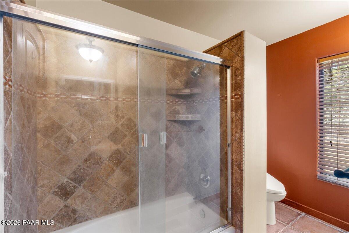 646 South Rancho Vista Drive Prescott, AZ 86303 - Photo 22 of 50 a bathroom with a glass shower door