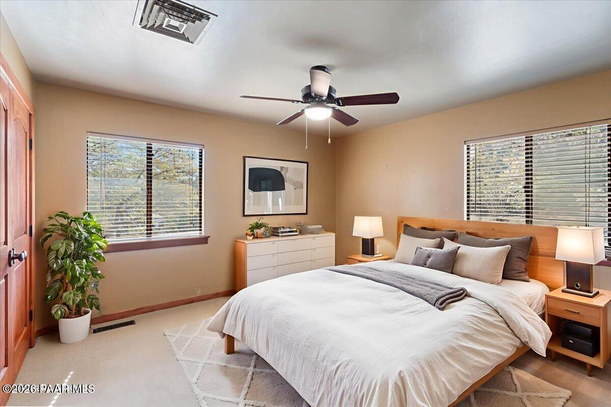 646 South Rancho Vista Drive Prescott, AZ 86303 - Photo 23 of 50 a bedroom with a large bed and a window