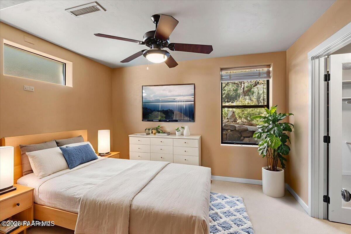 646 South Rancho Vista Drive Prescott, AZ 86303 - Photo 26 of 50 a bedroom with a bed and a flat screen tv