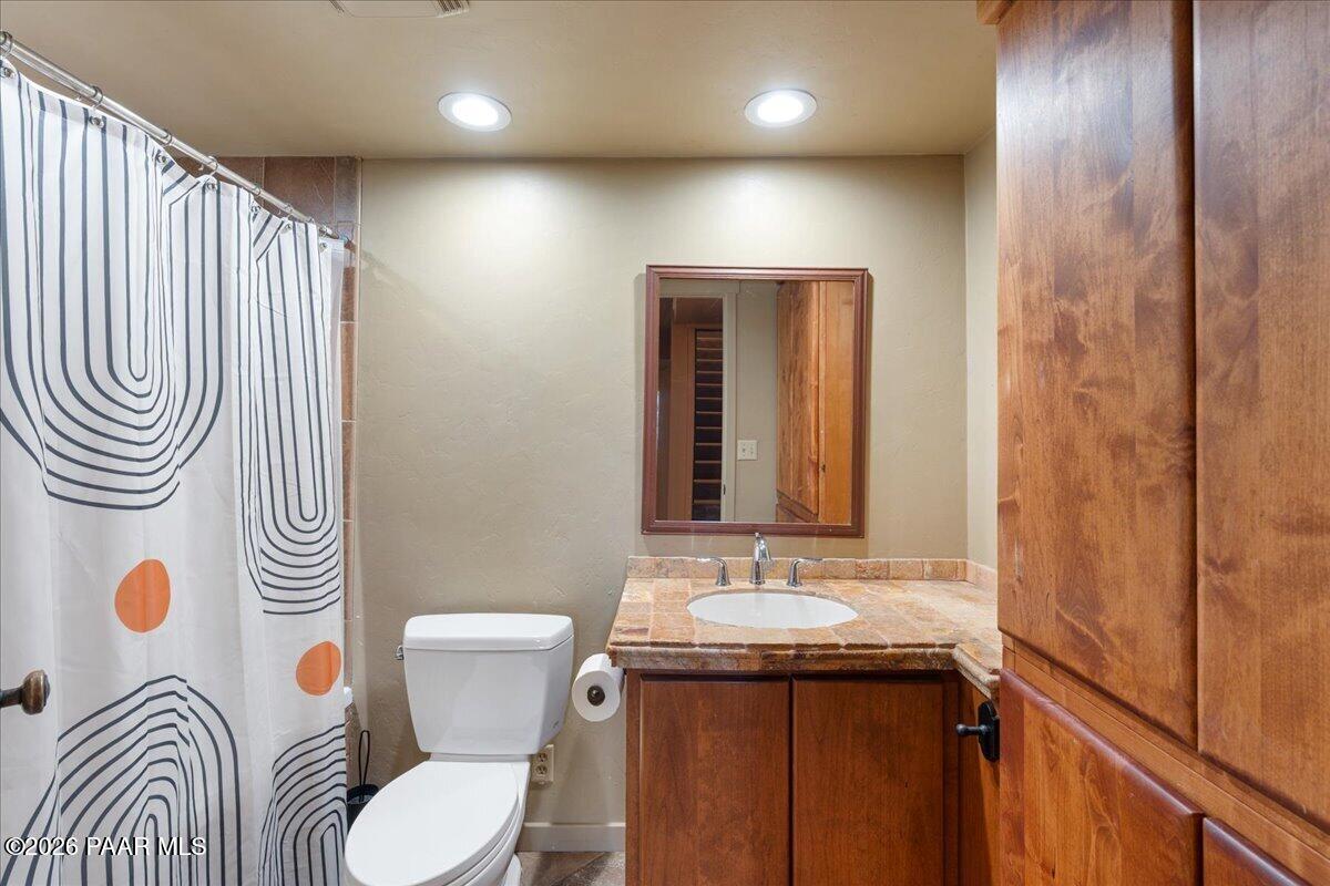 646 South Rancho Vista Drive Prescott, AZ 86303 - Photo 28 of 50 a bathroom with a sink a toilet and a mirror