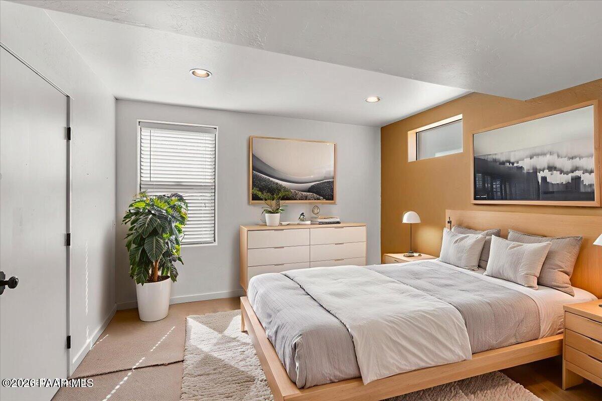 646 South Rancho Vista Drive Prescott, AZ 86303 - Photo 29 of 50 a bedroom with a bed and a potted plant